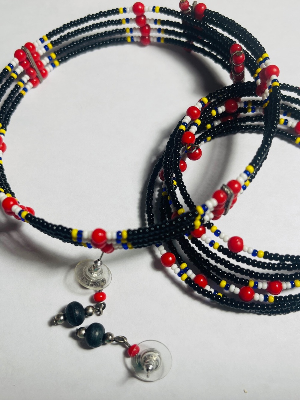 Handcrafted Black Seed Bead Coil Earrings with Red, Yellow & White Accents
